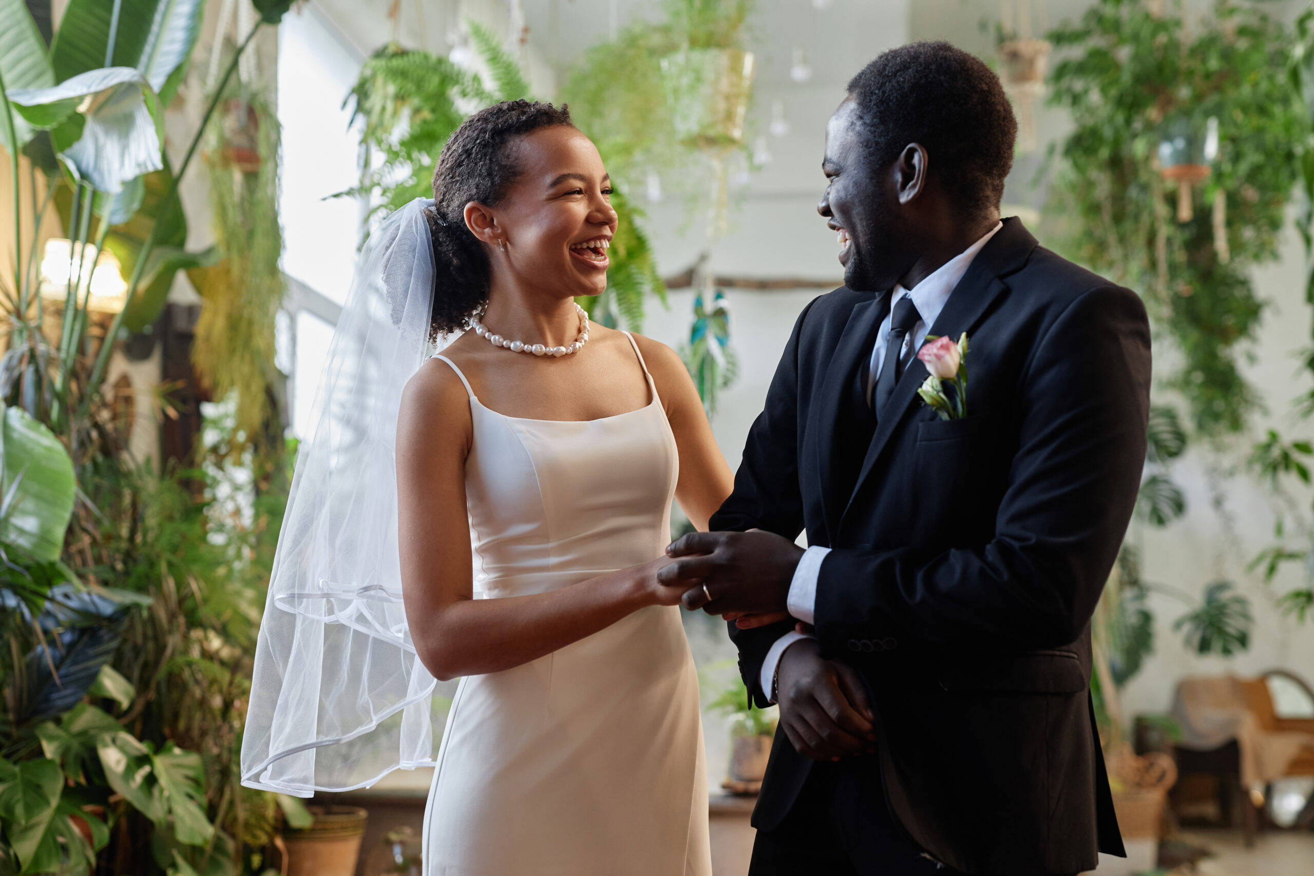 Black young couple getting married in tropical orangerie